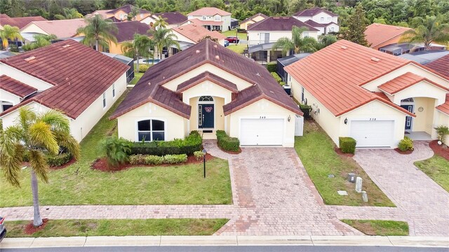 exterior space featuring a garage and a front lawn