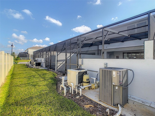 view of yard featuring central AC and a lanai