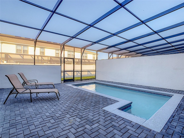 view of pool with a patio and a lanai