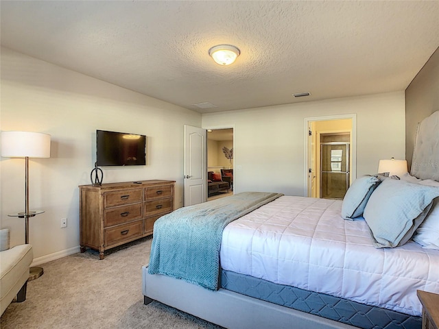 bedroom featuring a textured ceiling and carpet flooring