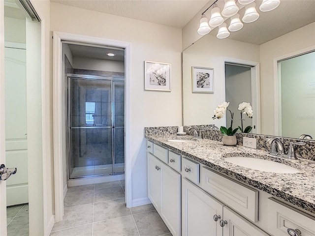 bathroom featuring double sink, tile flooring, and large vanity