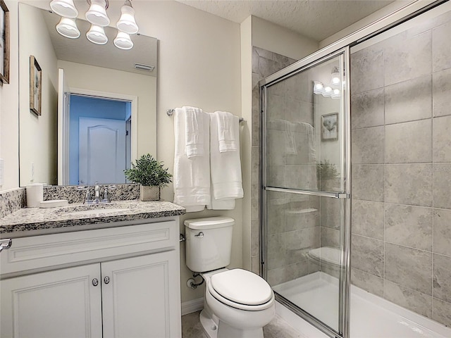 bathroom with walk in shower, a chandelier, oversized vanity, toilet, and a textured ceiling