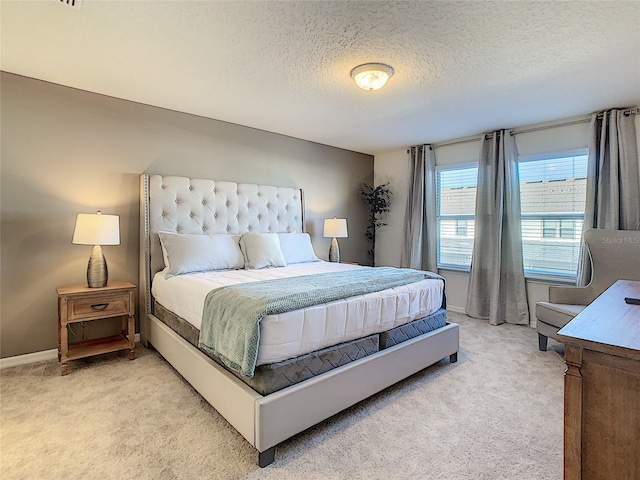 bedroom featuring a textured ceiling and carpet flooring