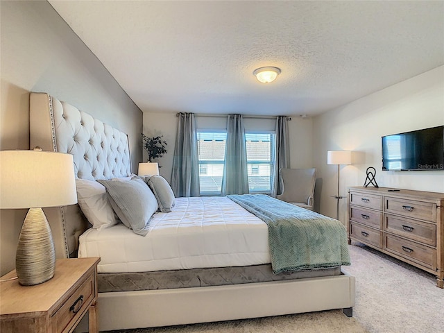 carpeted bedroom featuring a textured ceiling