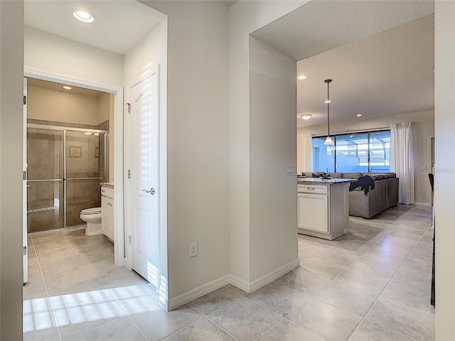 corridor featuring light tile floors