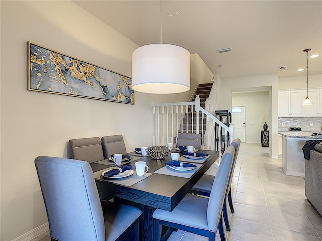 dining space with light tile floors