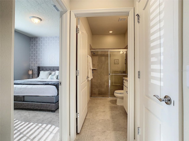 bathroom featuring vanity, tile floors, and toilet