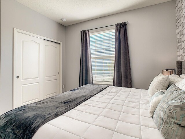 bedroom with a closet and a textured ceiling