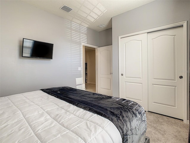 carpeted bedroom with a closet