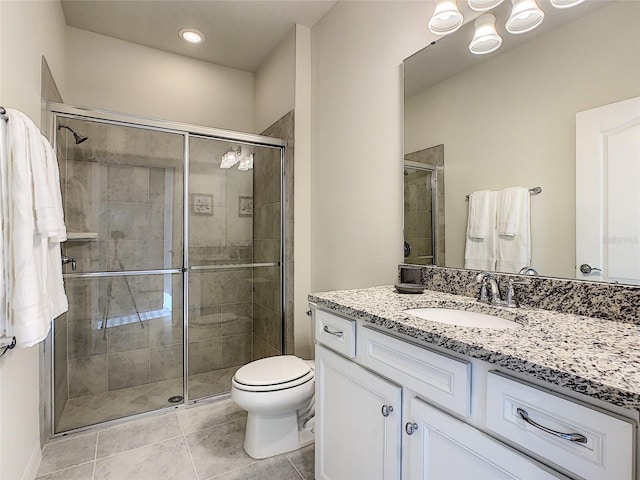 bathroom with an enclosed shower, toilet, vanity with extensive cabinet space, and tile flooring