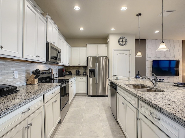 kitchen with stainless steel appliances, light tile flooring, tasteful backsplash, sink, and pendant lighting