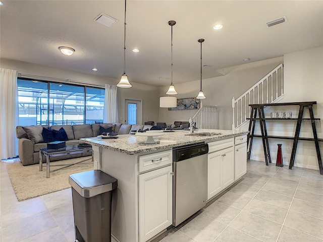 kitchen with a kitchen island with sink, white cabinets, pendant lighting, light tile floors, and stainless steel dishwasher