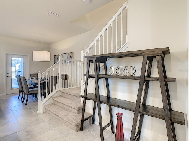 stairway with light tile floors