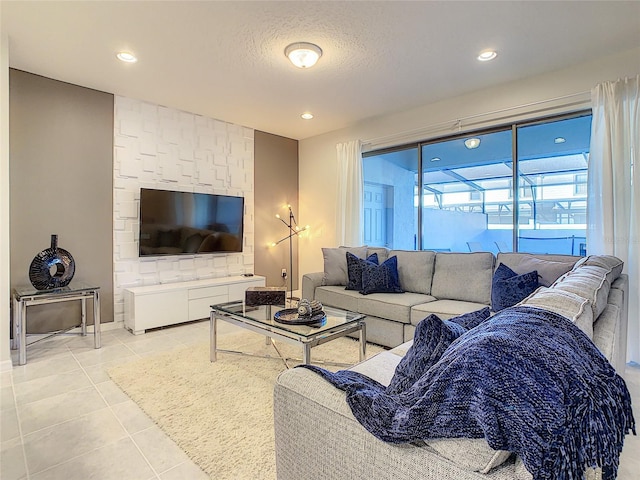 tiled living room featuring a textured ceiling