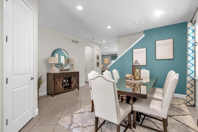 dining space with light tile flooring