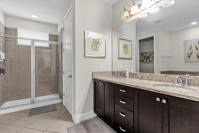 bathroom featuring walk in shower, dual vanity, and tile floors