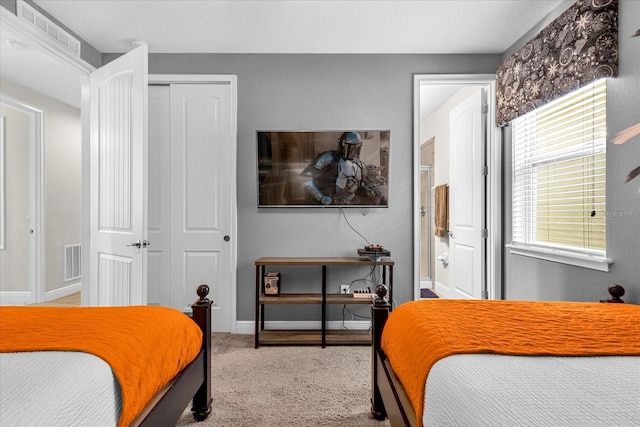 carpeted bedroom with a closet