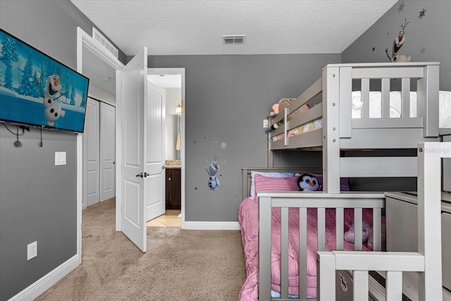 carpeted bedroom featuring a textured ceiling