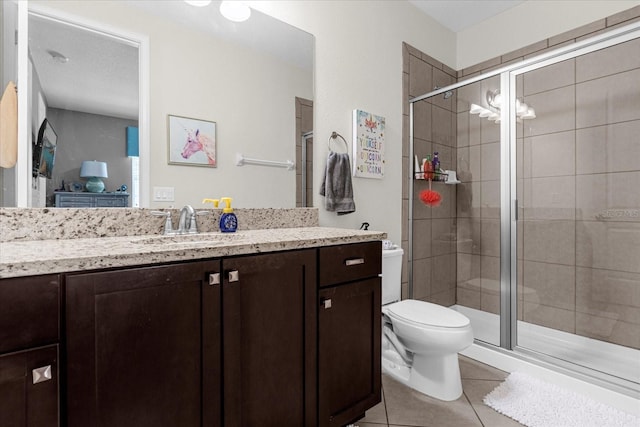 bathroom featuring a shower with shower door, toilet, tile floors, and vanity