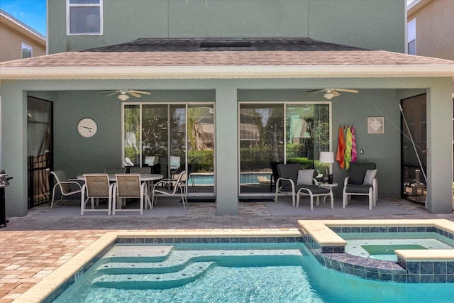 view of pool with a patio area, ceiling fan, and an in ground hot tub