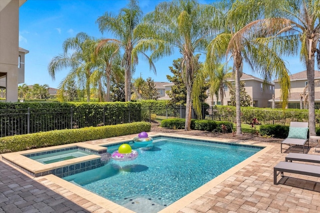 view of swimming pool with an in ground hot tub