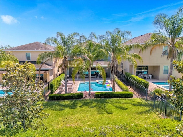 view of pool with a patio area and a yard