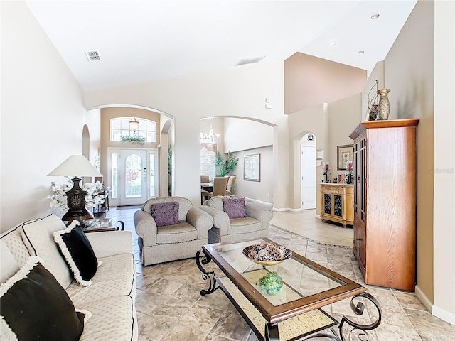 tiled living room with a towering ceiling