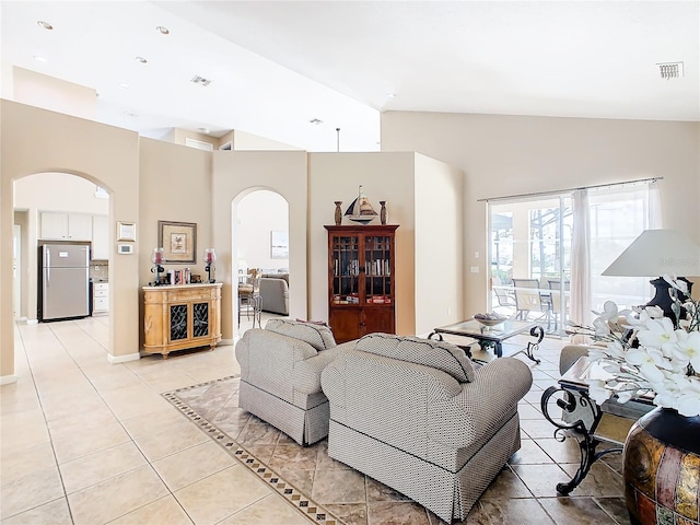 living room featuring light tile floors and lofted ceiling