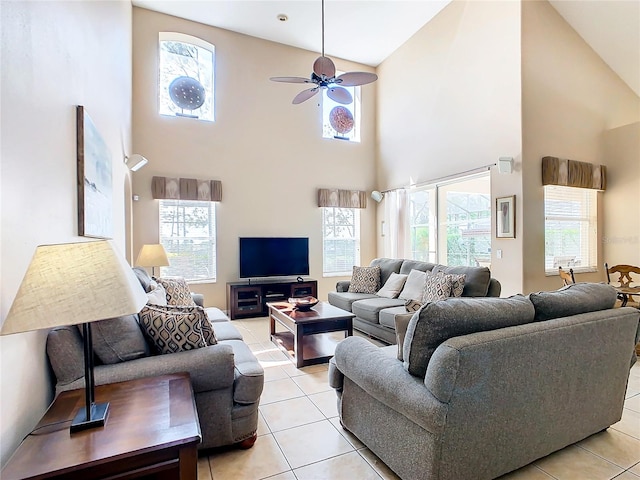 living room featuring plenty of natural light, high vaulted ceiling, tile flooring, and ceiling fan