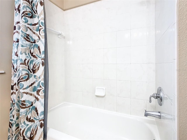 bathroom with shower / bath combo with shower curtain