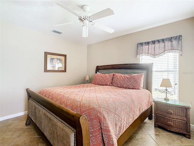 tiled bedroom with ceiling fan