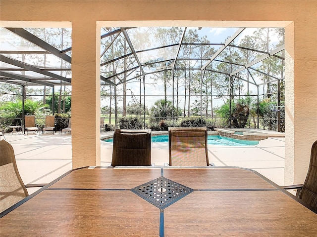 view of swimming pool featuring a patio, a lanai, and an in ground hot tub