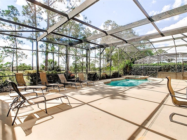 view of pool with a patio area, an in ground hot tub, and a lanai