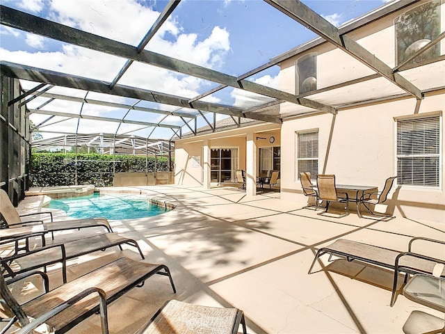 view of swimming pool featuring a patio and glass enclosure