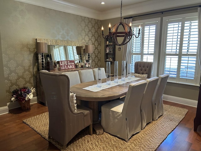 dining room with a notable chandelier, plenty of natural light, crown molding, and hardwood / wood-style flooring