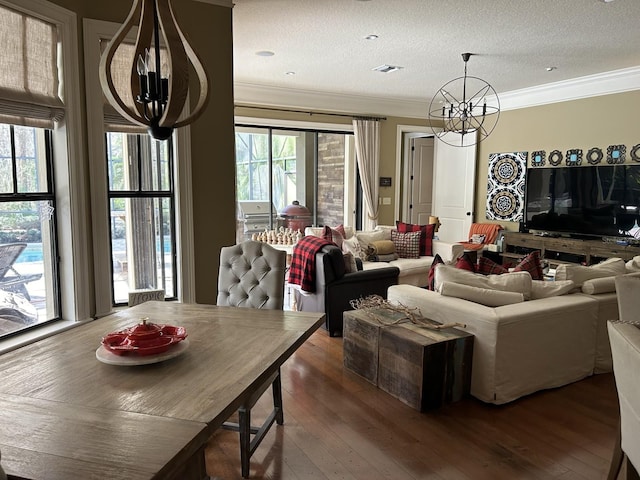 living room with plenty of natural light, dark hardwood / wood-style flooring, and an inviting chandelier