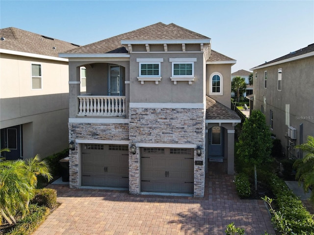 view of front facade with a garage and a balcony