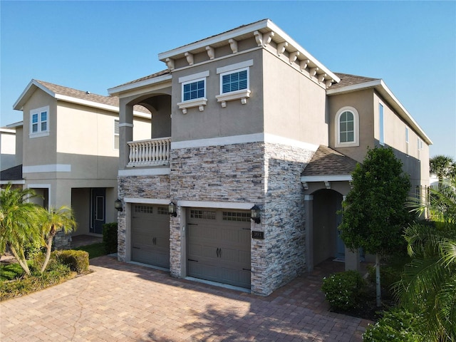 view of front facade featuring a balcony and a garage