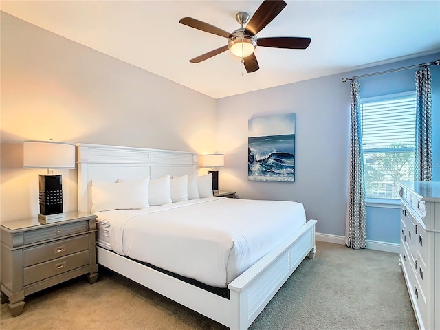 bedroom featuring light carpet and ceiling fan