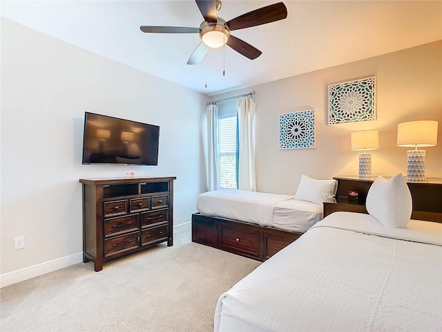 bedroom featuring ceiling fan and light carpet