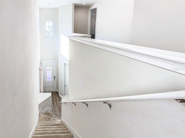 staircase with a towering ceiling