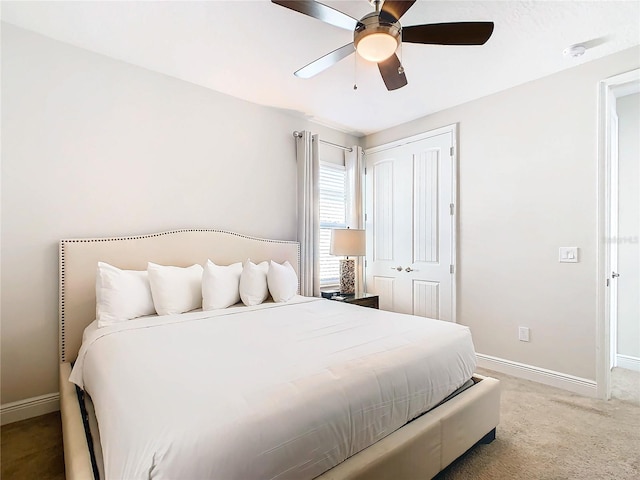 bedroom with a closet, ceiling fan, and carpet flooring