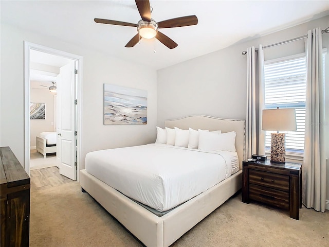 bedroom with ensuite bath, ceiling fan, and carpet