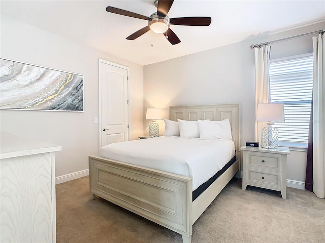 bedroom featuring ceiling fan and light carpet