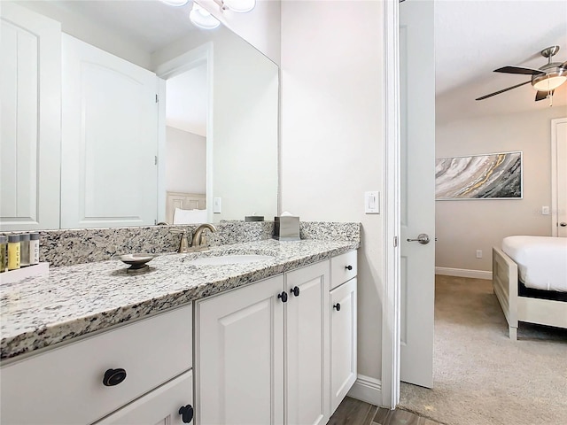 bathroom featuring ceiling fan and large vanity