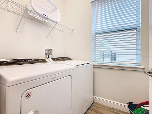 washroom featuring independent washer and dryer, washer hookup, and light hardwood / wood-style flooring