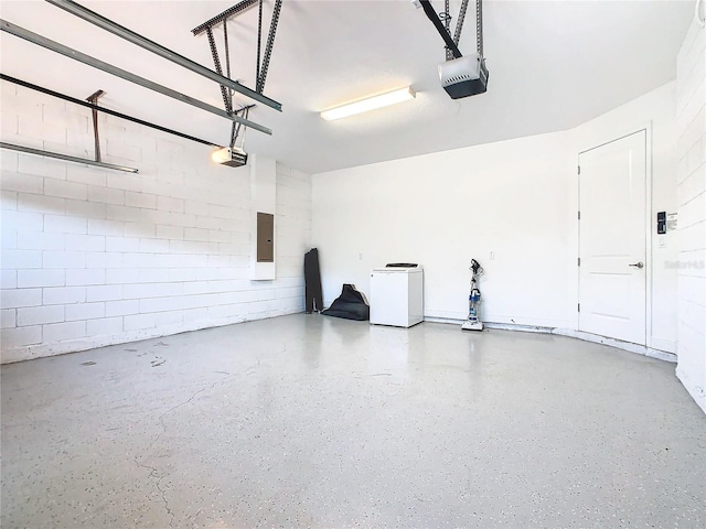 garage featuring fridge and a garage door opener