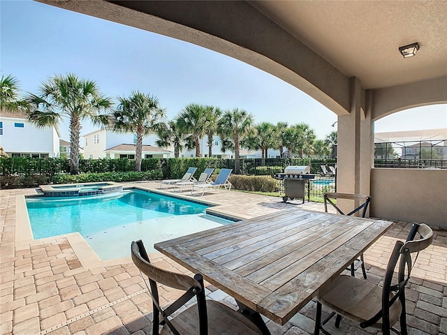 view of swimming pool with a patio and an in ground hot tub