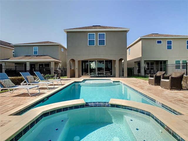 view of swimming pool featuring a patio and an in ground hot tub