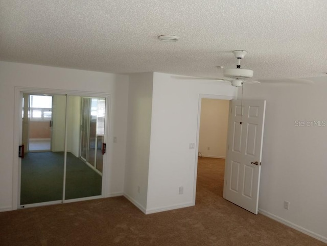 unfurnished bedroom featuring carpet flooring, a closet, ceiling fan, and a textured ceiling